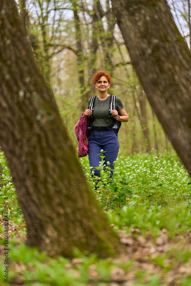 Woman hiking in spring forest