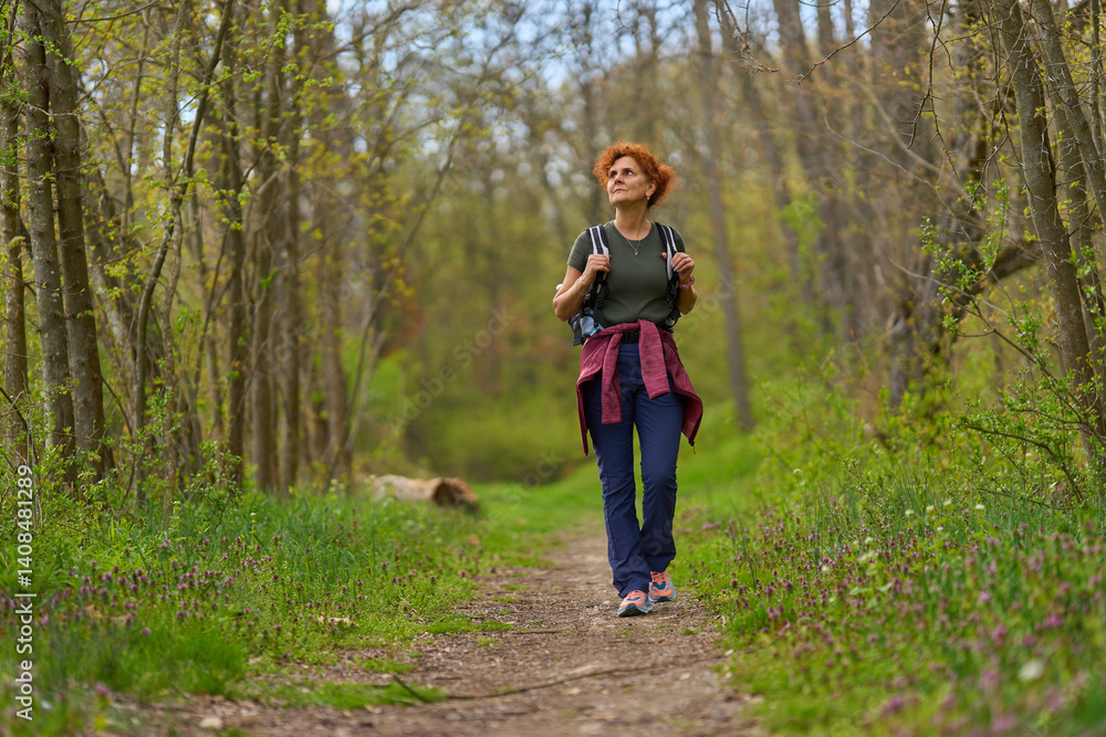 Woman hiking in spring forest