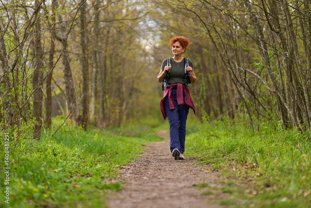 Woman hiking in spring forest