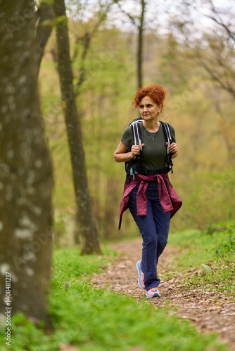 Obraz na płótnie Woman hiking in spring forest w salonie