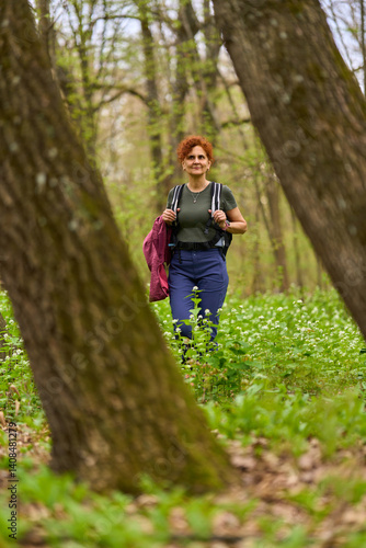 Obraz na płótnie Woman hiking in spring forest w salonie