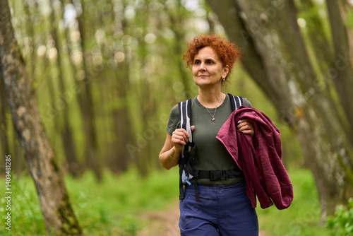 Obraz na płótnie Woman hiking in spring forest w salonie