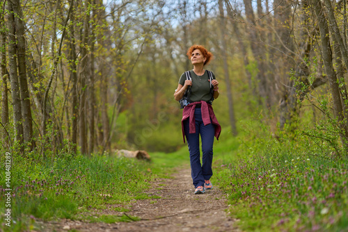 Obraz na płótnie Woman hiking in spring forest w salonie