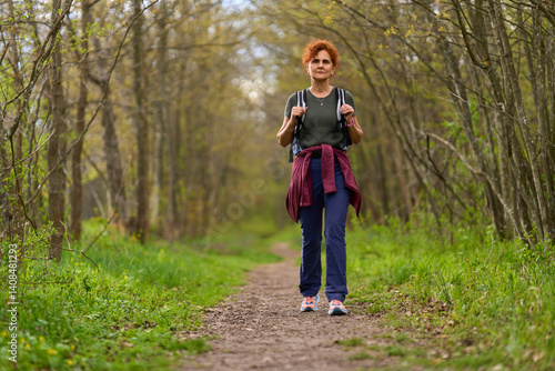 Obraz na płótnie Woman hiking in spring forest w salonie