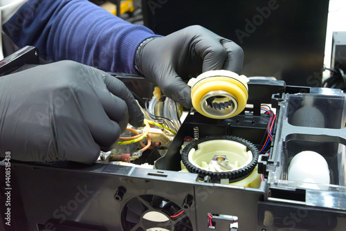 Fotografie Professional repair and cleaning technician for coffee machine parts with a sprocket grinder for whole bean and espresso, both commercial and home