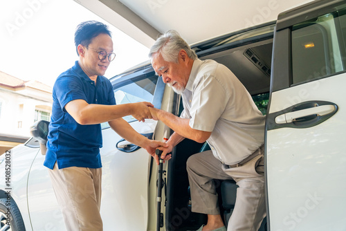 Asian man caregiver or taxi driver helping senior man patient get in the car to get to medical appointments or healthcare therapy sessions at hospital. Assisted elderly patient transportation services