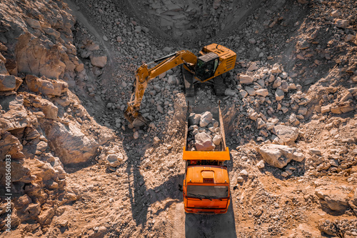 Excavator is loading raw stuff to truck at marble mining quarry