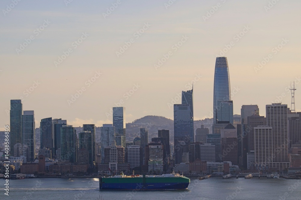 Fototapeta premium The sun sinks lower in the sky, casting shadows on the skyline of San Francisco