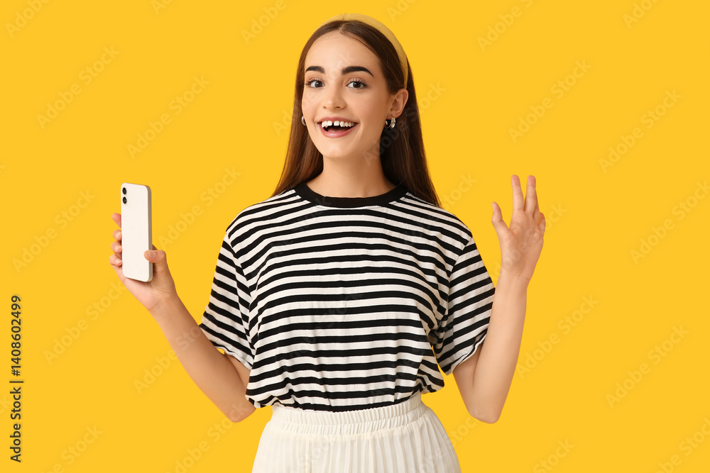 Young woman with diastema and mobile phone on yellow background Young woman with diastema and mobile phone on yellow background