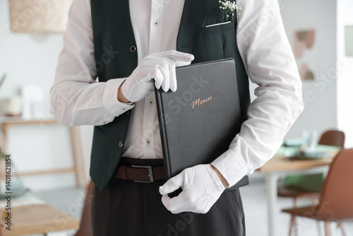 Male waiter with menu in re...