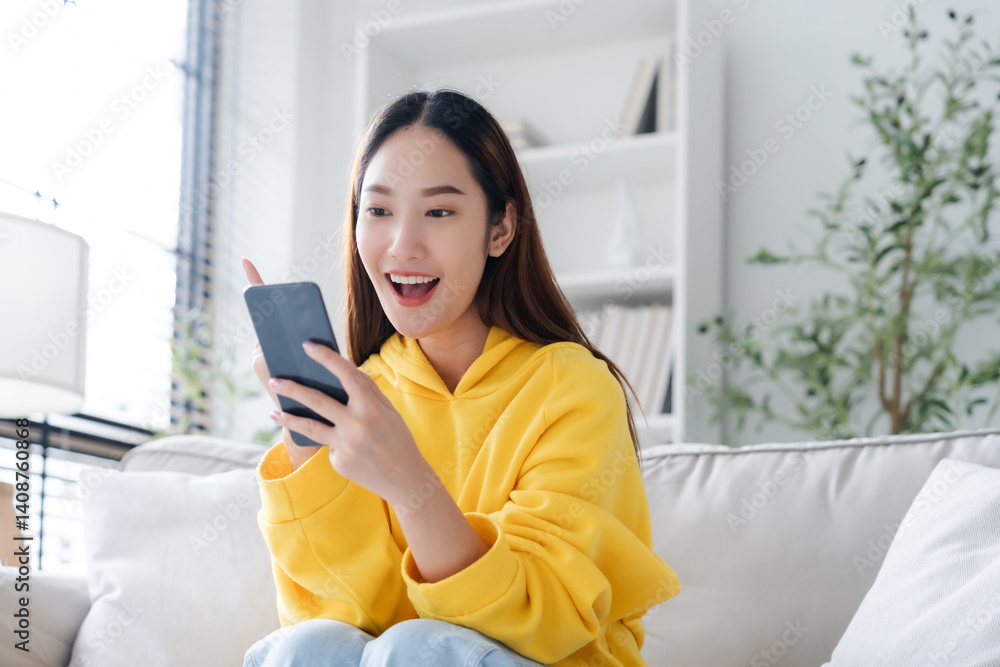 Happy young asian woman relax on comfortable couch at home texting messaging on smartphone, smiling girl use cellphone, chatting online message, shopping online from home Happy young asian woman relax on comfortable couch at home texting messaging on smartphone, smiling girl use cellphone, chatting online message, shopping online from home