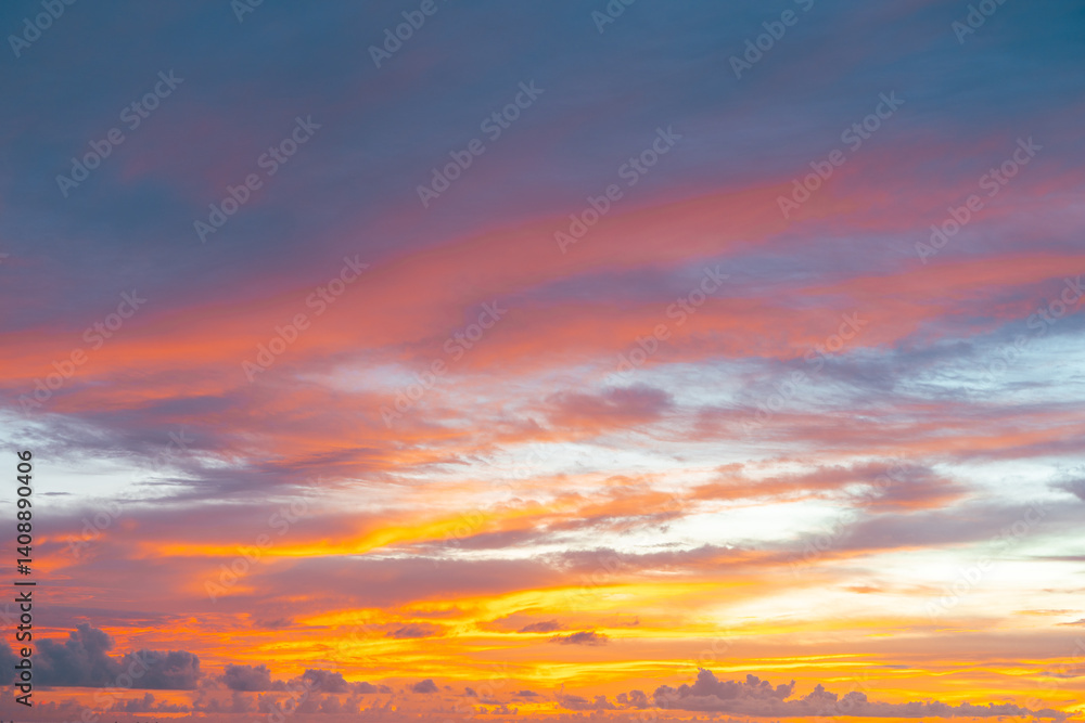 Fototapeta premium Sunset magic with bold orange hues lighting up twilight clouds in a colorful sky.