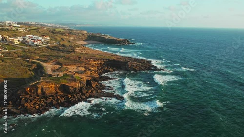 Beautiful rocky seascape with slow motion rolling waves to the shore. Aerial view: beautiful nature landscape. Drone view of scenic nature  in Portugal.  Beautiful coastline seascape in Europe.