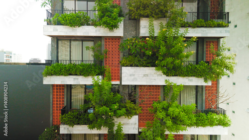 Green clad urban building featuring living walls and balcony gardens, representing contemporary sustainable architectural approach merging nature with city infrastructure