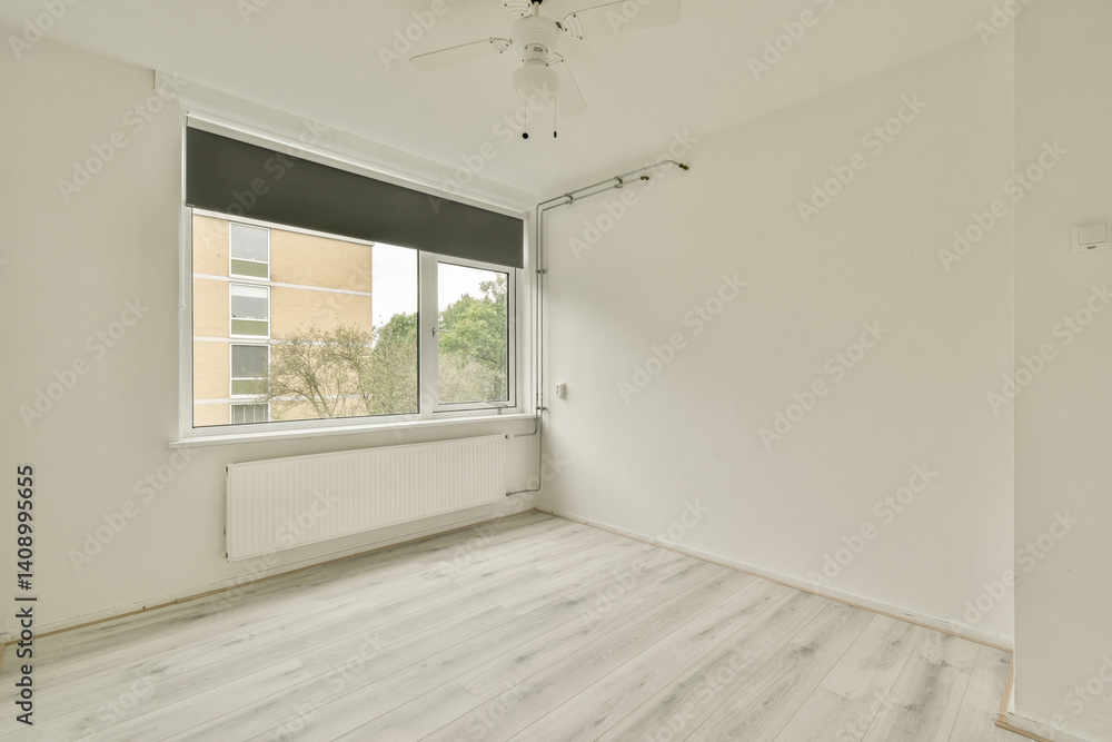 Fototapeta premium A minimalist interior featuring white walls and flooring, with a large window allowing natural light. The space is simple yet inviting, suitable for various decor styles.