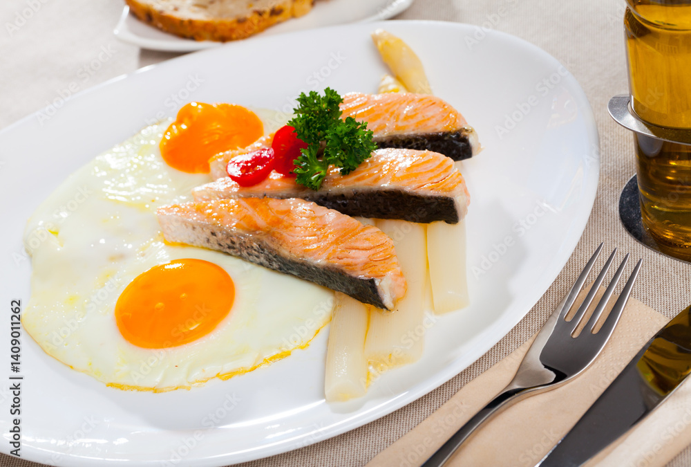 Fried salmon with scrambled eggs and asparagus. High quality photo Fried salmon with scrambled eggs and asparagus. High quality photo