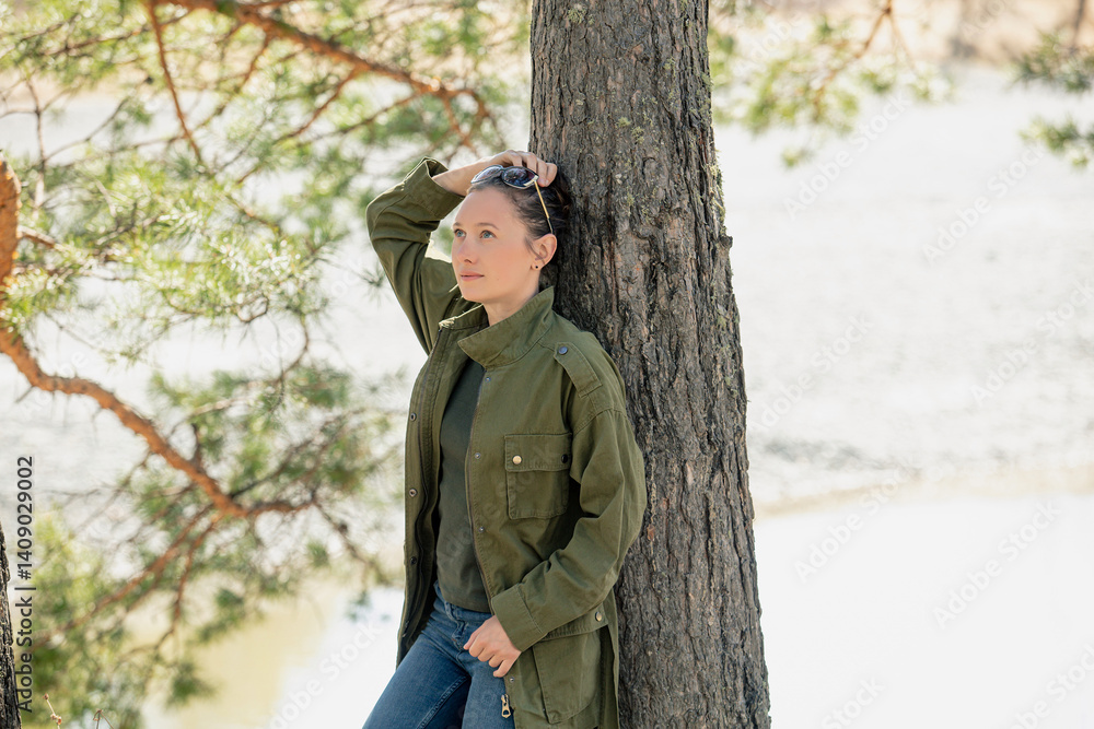 A female tourist in nature in the forest is relaxing at a campsite, happy A female tourist in nature in the forest is relaxing at a campsite, happy