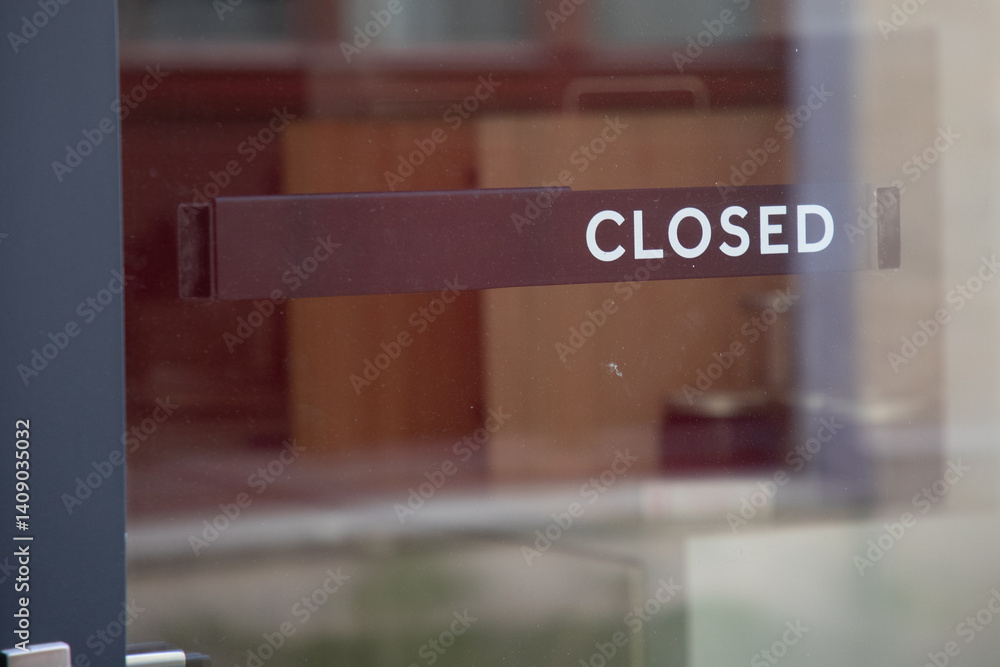 closed text sign hanging inside a restaurant store office or other door entrance