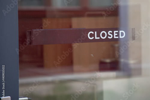 closed text sign hanging inside a restaurant store office or other door entrance