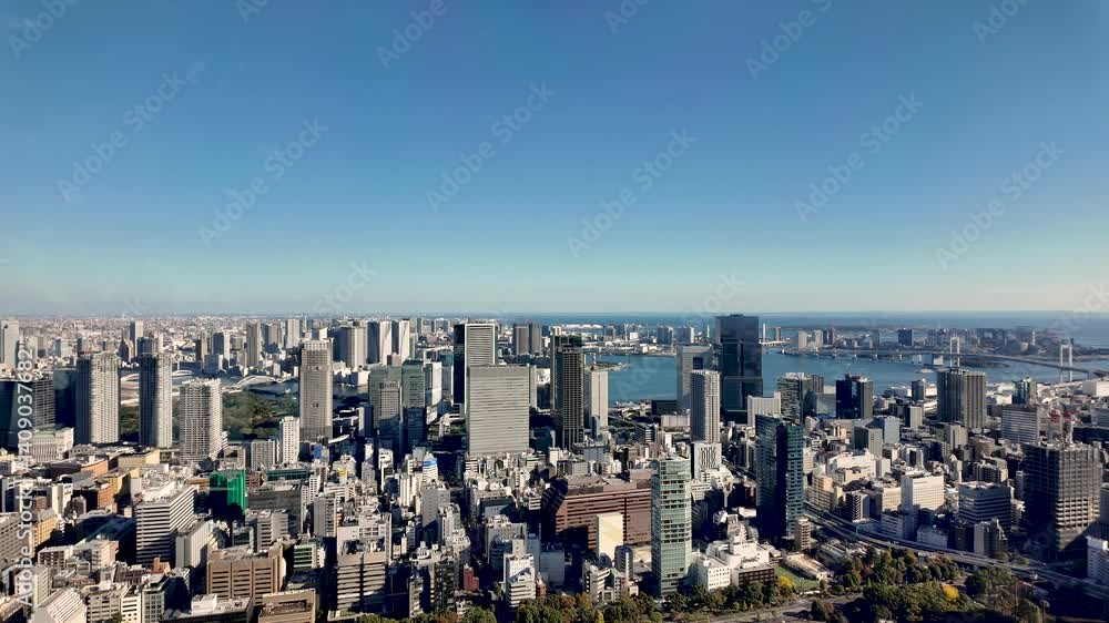 Panoramic view of modern Tokyo skyline, featuring urban skyscrapers and Tokyo Bay scenery. Panoramic view of modern Tokyo skyline, featuring urban skyscrapers and Tokyo Bay scenery.