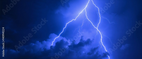 Lightning strikes illuminating dark clouds during night storm