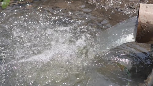 Wallpaper Mural Water Flowing from a Pipe into a Small Natural Stream Torontodigital.ca