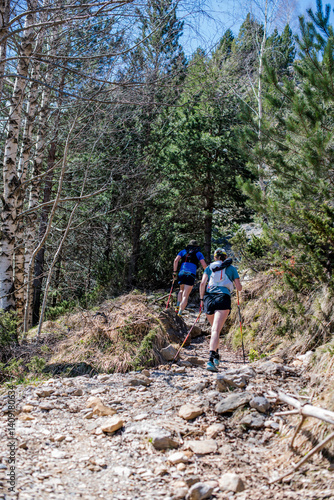 Couple hiking in the magnificent landscapes of the Cirque de Gavarnie in the Pyrenees, a UNESCO World Heritage Site.