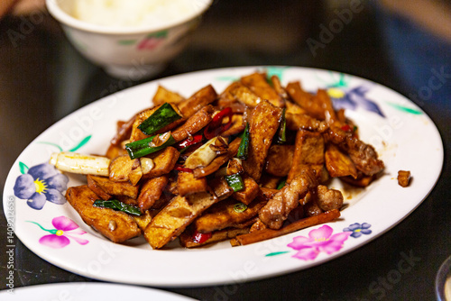 Hakka stir-fry with pork, dried tofu, and squid, showcasing the bold, savory flavors of traditional Hakka cuisine in Taiwan