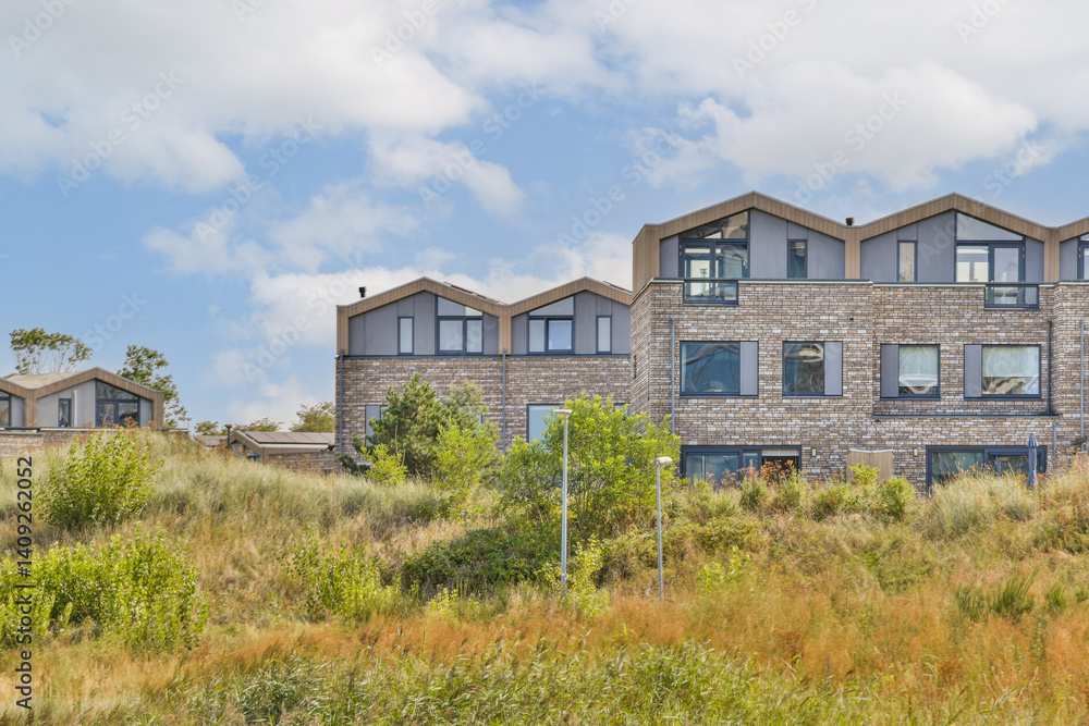 A striking modern building features a sleek design amidst lush greenery and clear blue skies, showcasing a harmonious blend of architecture and nature.
