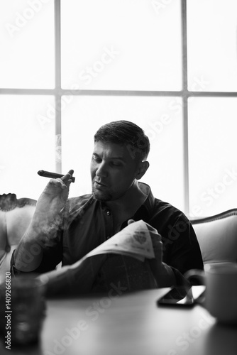 man reading morning newspaper smoking a cigar