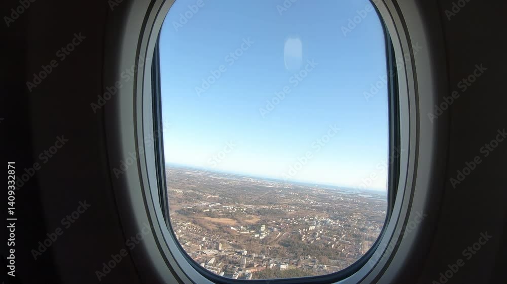 Aerial view from a plane window reveals an intricate cityscape sprawling beneath a sky slowly transitioning into soft morning light. Aerial view from a plane window reveals an intricate cityscape sprawling beneath a sky slowly transitioning into soft morning light.
