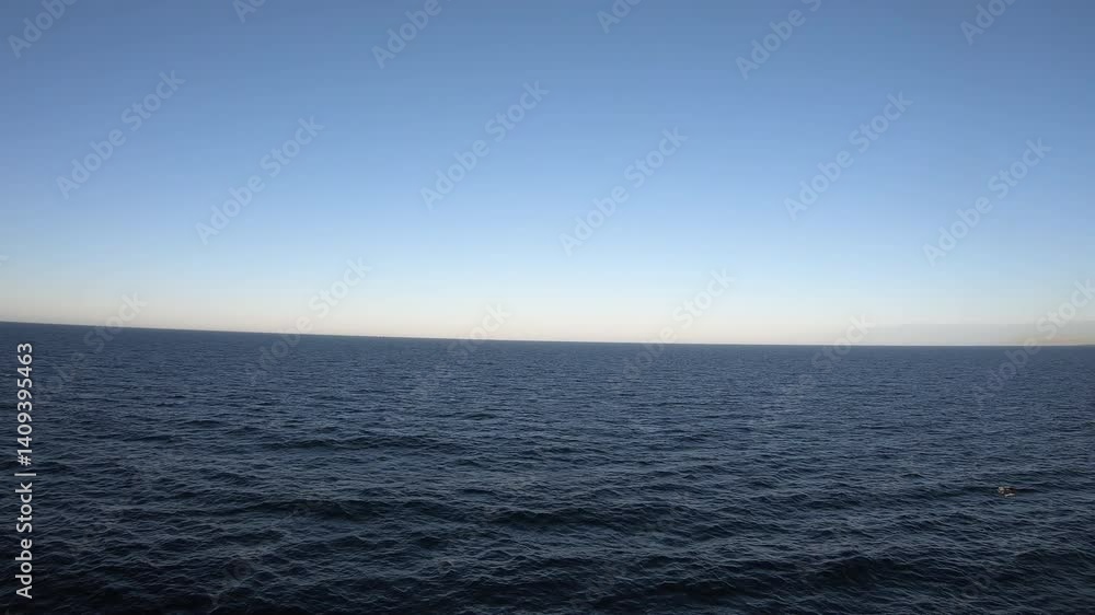 The deep endless sea merges into the horizon beneath a cloudless sky, creating a peaceful canvas of still, blue vastness. The deep endless sea merges into the horizon beneath a cloudless sky, creating a peaceful canvas of still, blue vastness.