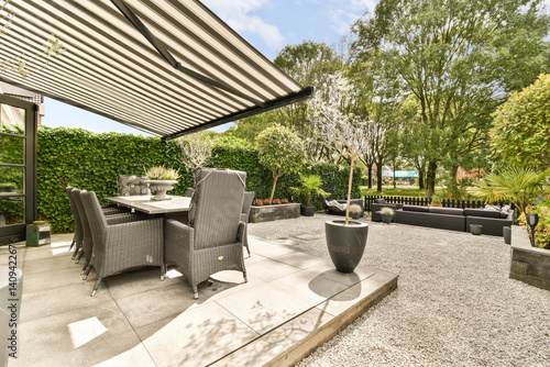 Canvas Print A stylish outdoor patio featuring sleek furniture, greenery, and a peaceful ambiance, perfect for relaxation and social gatherings