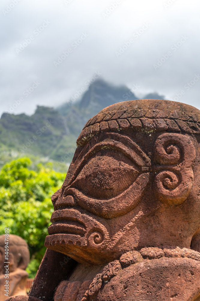 Ancient tiki statue with Mount Temetiu, Hiva Oa, French Polynesia