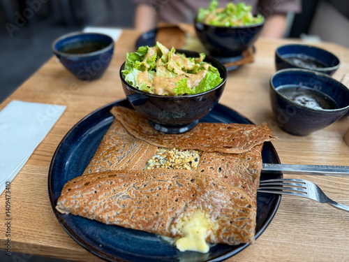 Photos Traditional Crepe Galette made from buckwheat flour with cheese and nuts on a pl