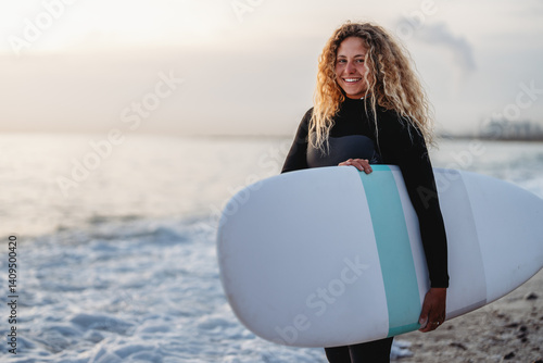 Obraz na płótnie Woman with surfing board at beach, sea and ocean for summer holiday, travel adventure or hobby. w salonie