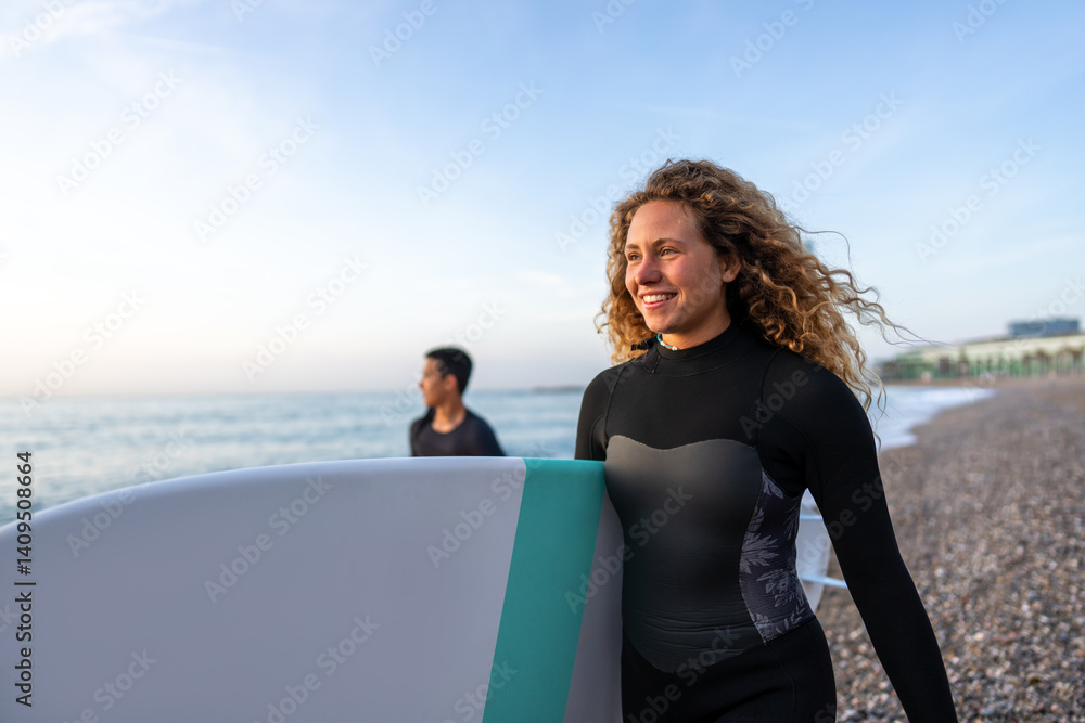 Joyful young woman carrying a surfboard on a beach, her face filled with happiness and excitement