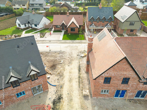 Obraz na płótnie Aerial view of near completed affordable and private homes on a rural housing development in the east of England. The distance shows private bungalows. w salonie