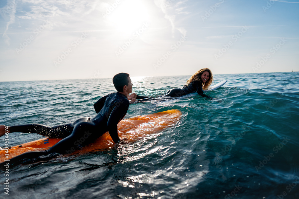 Young people having fun, enjoying their vacations outdoors at the beach with surfboards. Sport, surf