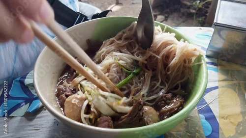 Rice Noodles Beef Soup with Beef Intestine Braised ontop Garlic and Stink Weed decorate Spring onions and Basil Thai herbs. Thai Boat Noodles Style topview