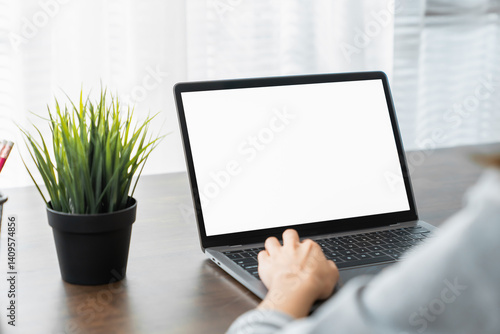 Hand using a computer laptop with a blank screen on table, for putting advertising to promote