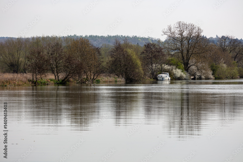 Boat moored along River Thames with spring blossom, Goring-on-Thames, Oxfordshire, England, United Kingdom, Europe Boat moored along River Thames with spring blossom, Goring-on-Thames, Oxfordshire, England, United Kingdom, Europe