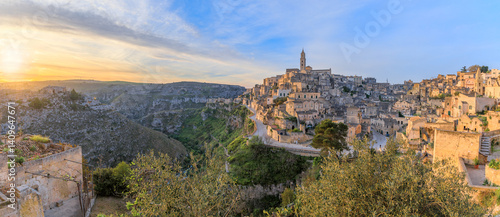 Cityscape of the Sassi di Matera at sunrise, in Basilicata, Southern Italy: view of the Sasso Barisano district overlooking the ravine of the Murgia Materana with cave houses.