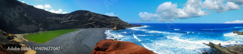 Obraz na płótnie Panoramic view of El Golfo on the island of Lanzarote, Canary Islands. Contrast between the vivid green lagoon (Charco de los Clicos), black volcanic sand, red lava rocks, and the deep blue Ocean w salonie