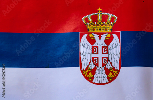 Fotografía Serbian flag with the coat of arms, full frame