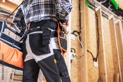 Construction Worker Preparing Tools in a Busy Workshop Space