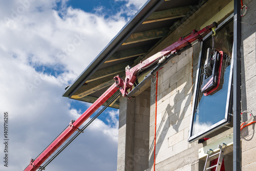 Construction Worker Using Boom Lift for Window Installation
