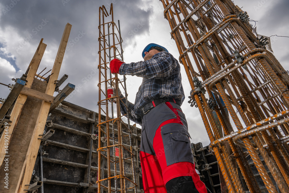 Construction Worker Assembling Rebar Framework at a Building Site