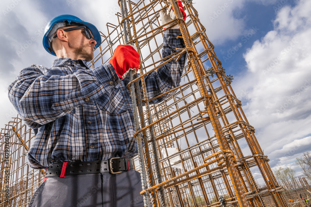 Construction Worker Assembling Steel Framework on a Site