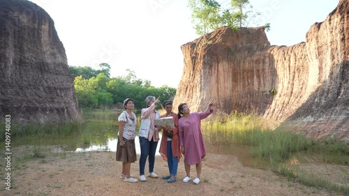 Group of Asian retirement women travelling, hiking, walking together, senior pensioner friends spend time experience using map direction in forest, elderly aging society lifestyle tourist one-day trip